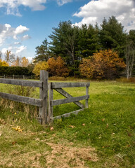 old wood gate leading into a farm pasture on a lovely autumn day