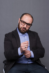 Armenian man in a shirt with a beard on a gray background in the studio