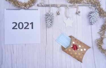 Christmas Covid 19 concept. Christmas gift with a mask inside the package. Year 2021. copy space