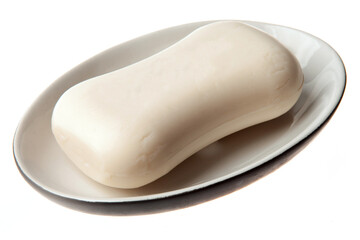 A bar of natural white soap in a soap plate isolated on white background. Studio shot. Hygiene theme - bacteria and virus prevention