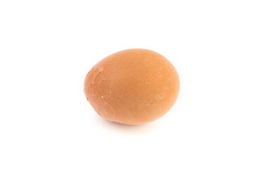 Egg with broken shell closeup on white background.