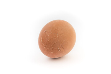 Egg with broken shell closeup on white background.