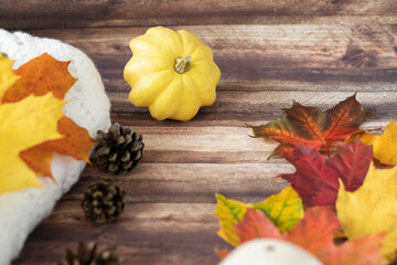 Autumn decoration with leaves, cones, cups, sweaters