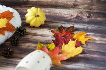 Autumn decoration with leaves, cones, cups, sweaters