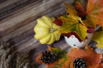 Autumn decoration with leaves, cones, cups, sweaters