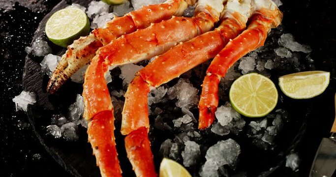 Boiled crab on a stone board with ice and lime slices. 