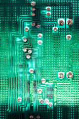 Electronic printed circuit board background with many electrical components, hardware. Green color