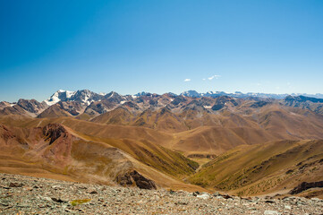 Rocky pass with mountain top views in high mountains. Young men and women hiking near Sary Chelek...