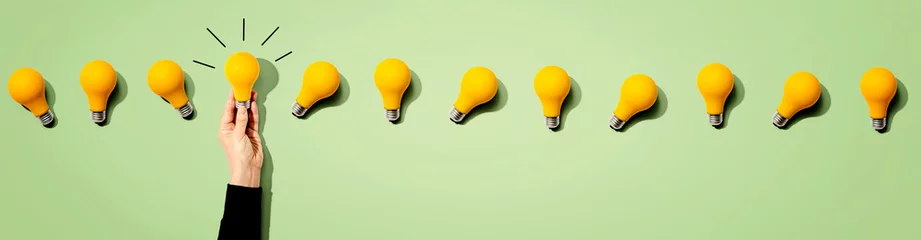 Foto op Plexiglas Many yellow light bulbs - Idea and creativity theme © Tierney
