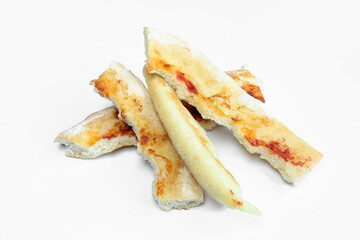 Crusty pizza leftovers isolated on white background. Food waste