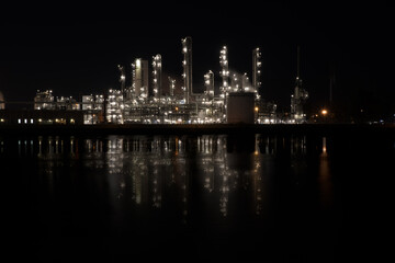 lights of a industrial factory reflecting in the water
