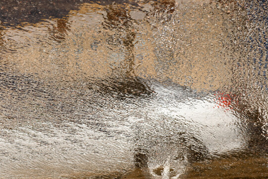 Abstract Blurred Car Reflection In A Puddle