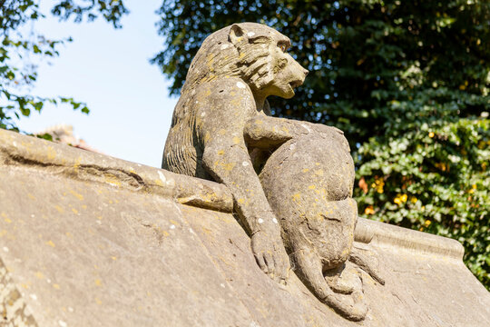 Baboon monkey sculpture from the Animal Wall of Cardiff Castle in Wales built in 1890 in Castle Street which is a popular travel destination tourist attraction landmark of the city stock photo image