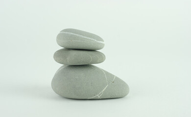 Stack of three grey beach rocks or stones