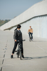 Woman riding ebike, she looking at her boyfriend, who fell behind