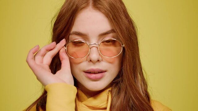 Playful woman biting lip indoors. Sexy ginger hair girl flirting on camera