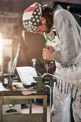 Male carpenter working in a retro vintage workshop.