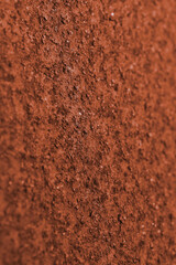 Dark ocher background or wallpaper. Vertical textured backdrop. Rough matte surface. A toned shot...