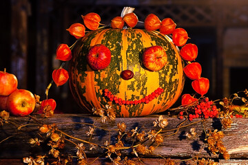Decorated pumpkin, on a black background. The concept of autumn, harvest, halloween. 