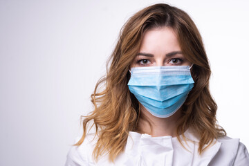 Protection against contagious disease, coronavirus. Female  wearing hygienic face surgical medical mask. Banner panorama medical staff preventive gear. Studio Photo, White edit space