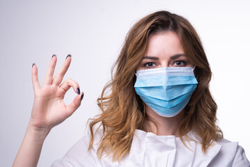 Protection against contagious disease, coronavirus. Female  wearing hygienic face surgical medical mask. Banner panorama medical staff preventive gear. Studio Photo, White edit space