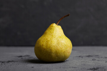 Tasty fresh pear on cocnrete background. 