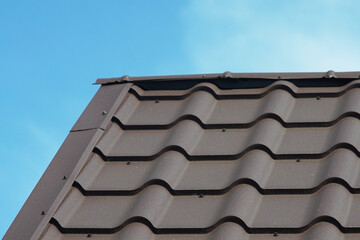 Fototapeta premium Metal tile roof of grey color.