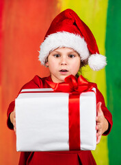 Kid hold present box colorful background. Xmas gift shopping. Family tradition. Winter holidays. Beautiful gift package. Give away. Merry Christmas and happy holidays. Little girl hold gift box