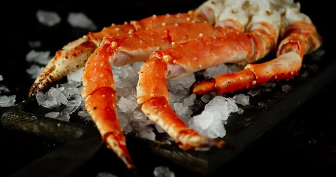 Boiled crab with pieces of ice slowly rotates. 