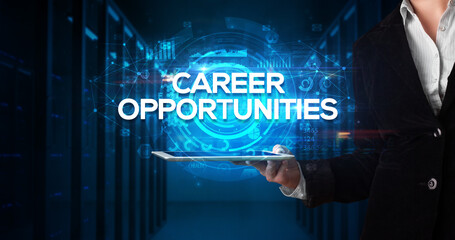 Young business person working on tablet and shows the inscription: CAREER OPPORTUNITIES, business concept