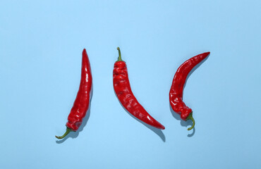 Chilli peppers on a blue background. Top view