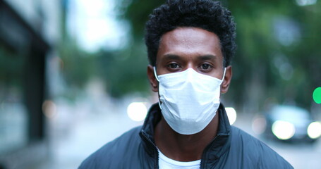African american black man putting on virus anti-pollution mask and walking forward to camera