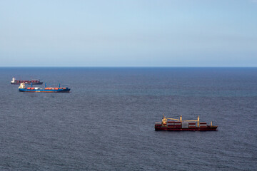 cargo ships waiting in the sea