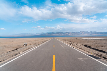 road in the desert to the lake 