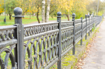 Fence in the Park on a cloudy autumn day
