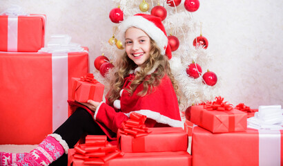 Obraz na płótnie Canvas Unpacking christmas gift. Kid excited about christmas present. Girl celebrate christmas. Santa bring her gift. Dreams come true. Winter happiness concept. Explore christmas gifts. Winter miracle