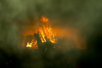 Firefighters battled the raging fire with large flames that burned down residential buildings.