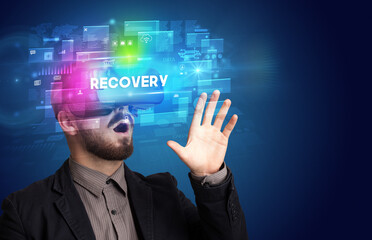 Businessman looking through Virtual Reality glasses with RECOVERY inscription, innovative security concept