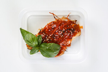 Fish in sauce in a lunch box. Healthy lunch to go