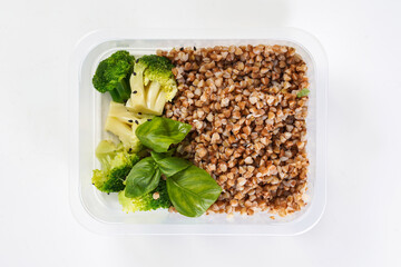 Buckwheat and broccoli in a lunch box. Healthy lunch to go