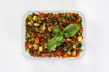 Buckwheat with corn and vegetables in a lunch box. Healthy lunch to go