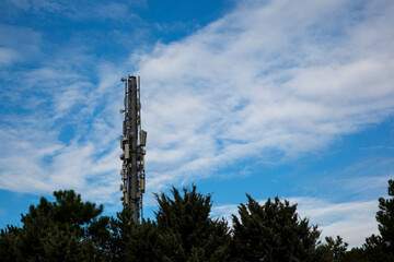 Radio transmitter standing in front of the cloudy sky