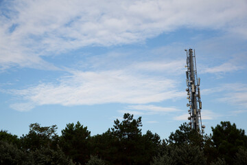 Radio transmitter standing in front of the cloudy sky