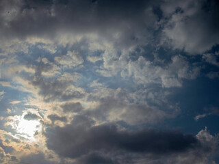 A Dramatic Mixture of Dark and Light Cumulus Clouds Through Which the Rays of a Bright Sun Break Through