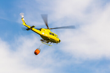 Fire-fighting helicopter flies for water from the Guadalest reservoir.