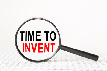 text TIME TI INVENT in a magnifying glass, office concept, business concept, Finance