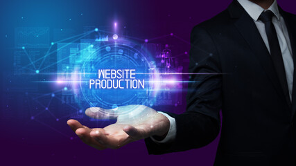 Man hand holding WEBSITE PRODUCTION inscription, technology concept