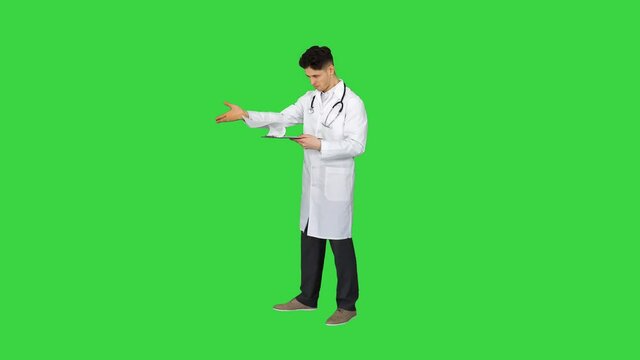 Angry male doctor looking at documents on a Green Screen, Chroma Key.