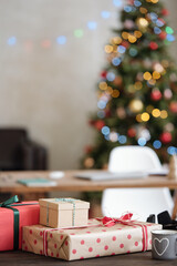 Stack of packed Christmas gifts wrapped into paper and bound with ribbons