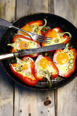 Selective focus. Red peppers with egg, baked in a pan. Healthy food. Autumn lunch.